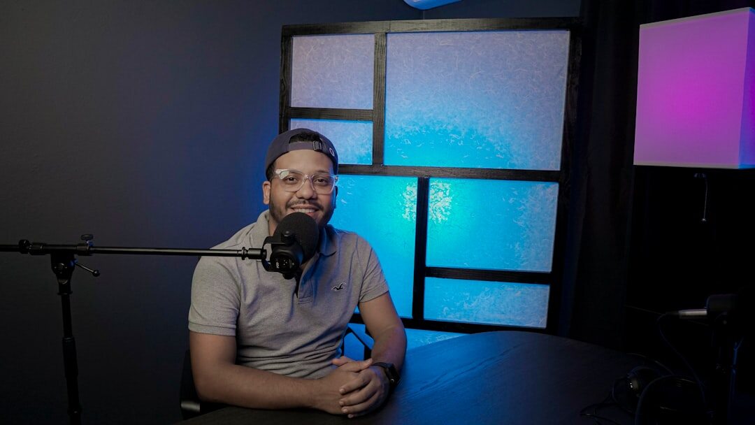 Atmospheric dark podcast studio with glowing equipment and ambient lighting